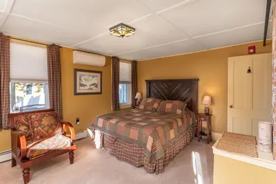 Spacious master bedroom with king bed and mountain views