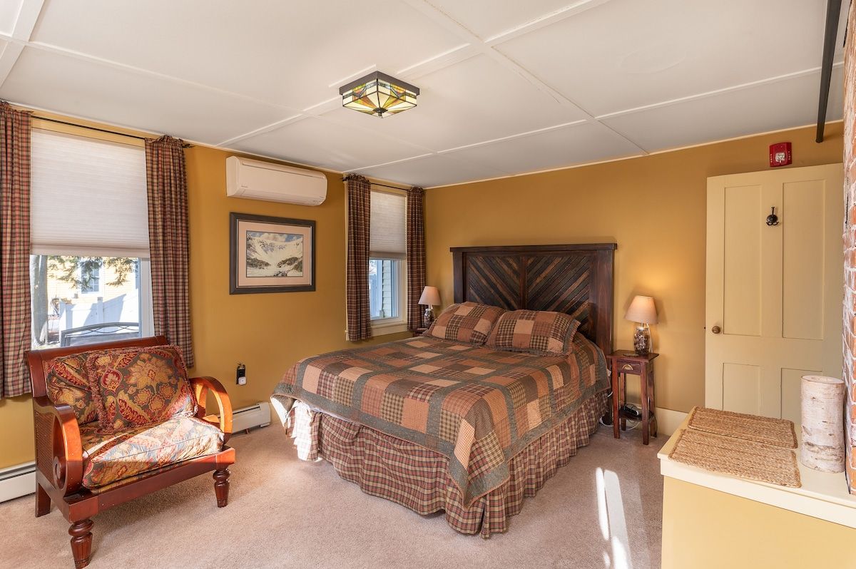 Spacious master bedroom with king bed and mountain views
