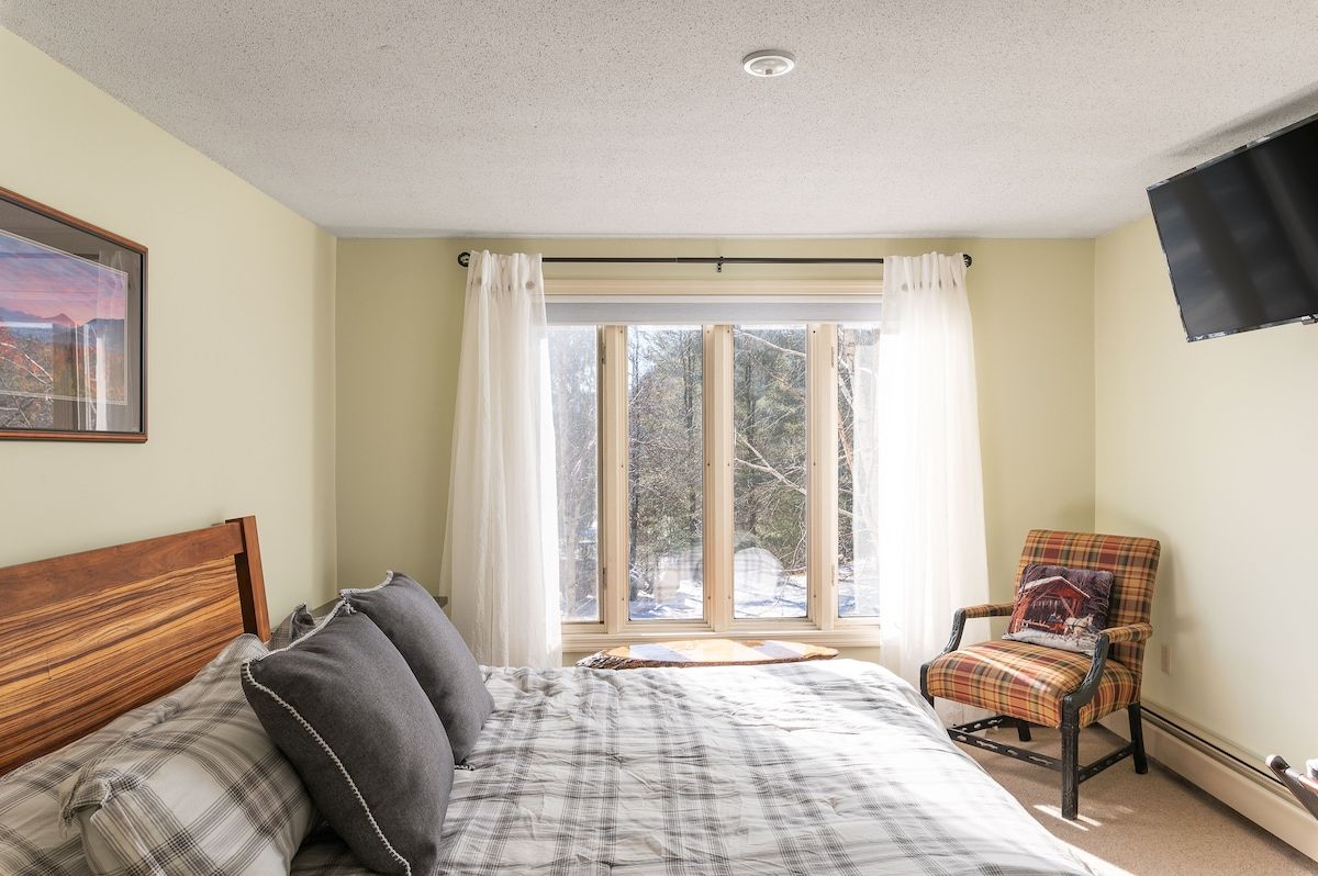Spacious master bedroom with king bed and mountain views