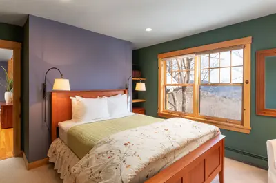 Spacious master bedroom with king bed and mountain views