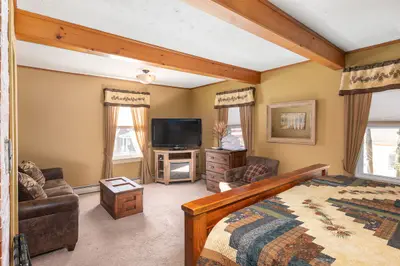 Spacious master bedroom with king bed and mountain views