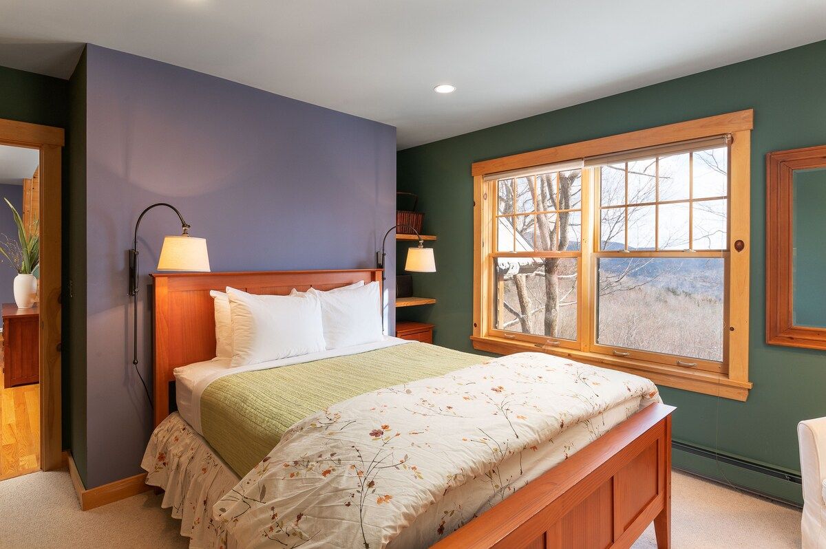 Spacious master bedroom with king bed and mountain views