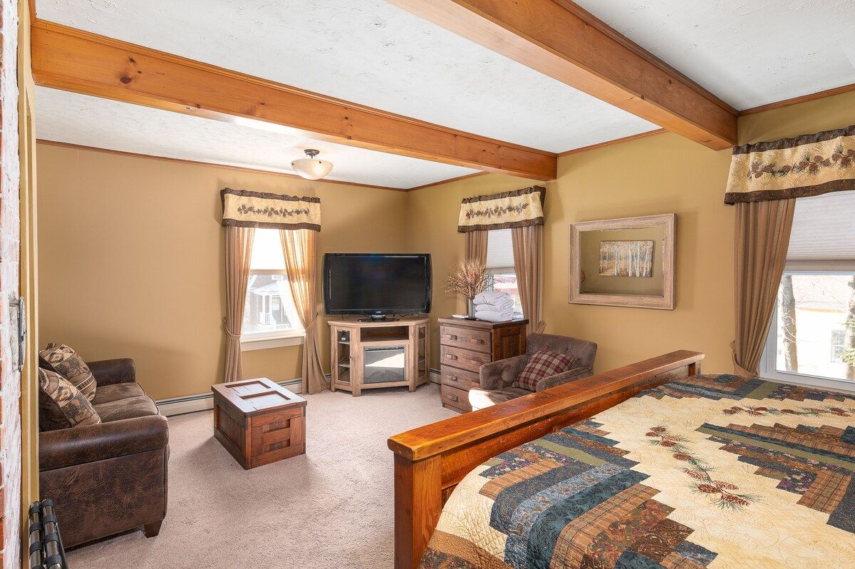 Spacious master bedroom with king bed and mountain views