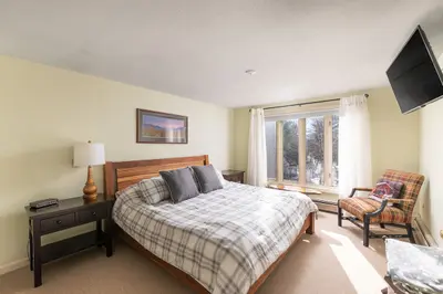 Spacious master bedroom with king bed and mountain views