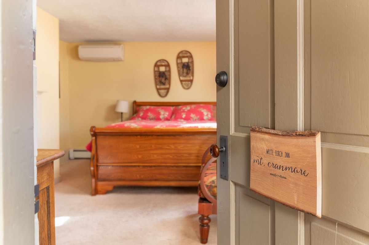 Spacious master bedroom with king bed and mountain views