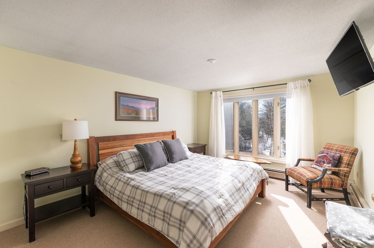 Spacious master bedroom with king bed and mountain views