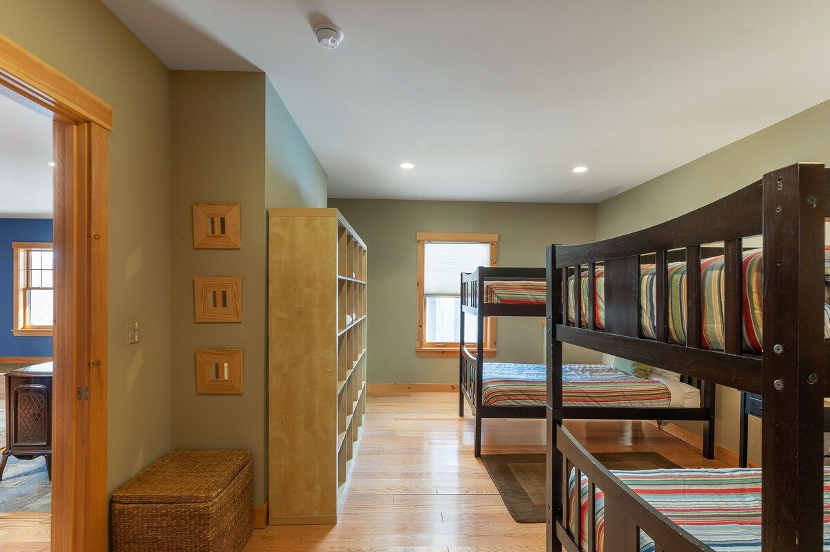 A cozy bedroom with bunk beds and a window, perfect for a family vacation