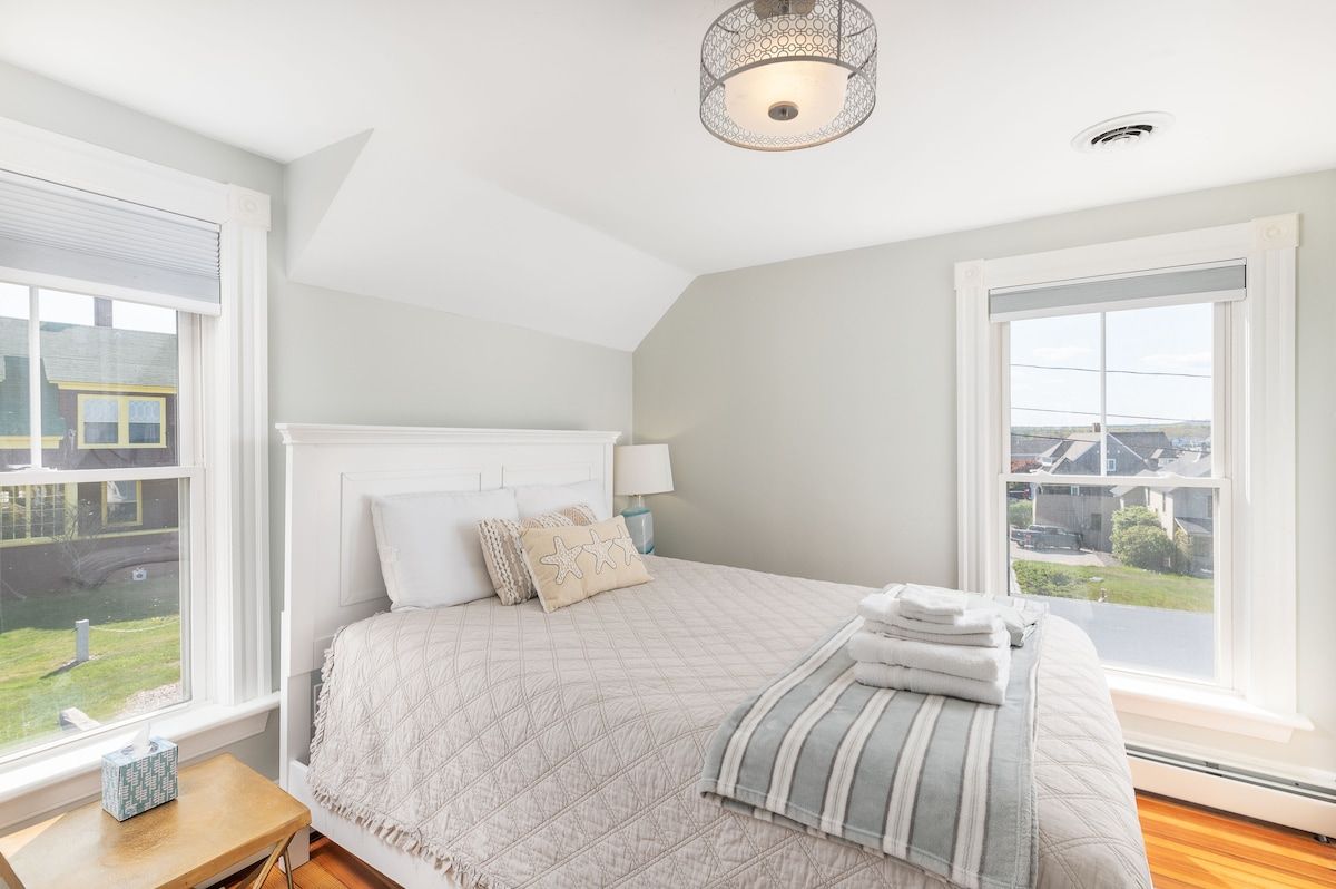 Spacious master bedroom with king bed and mountain views
