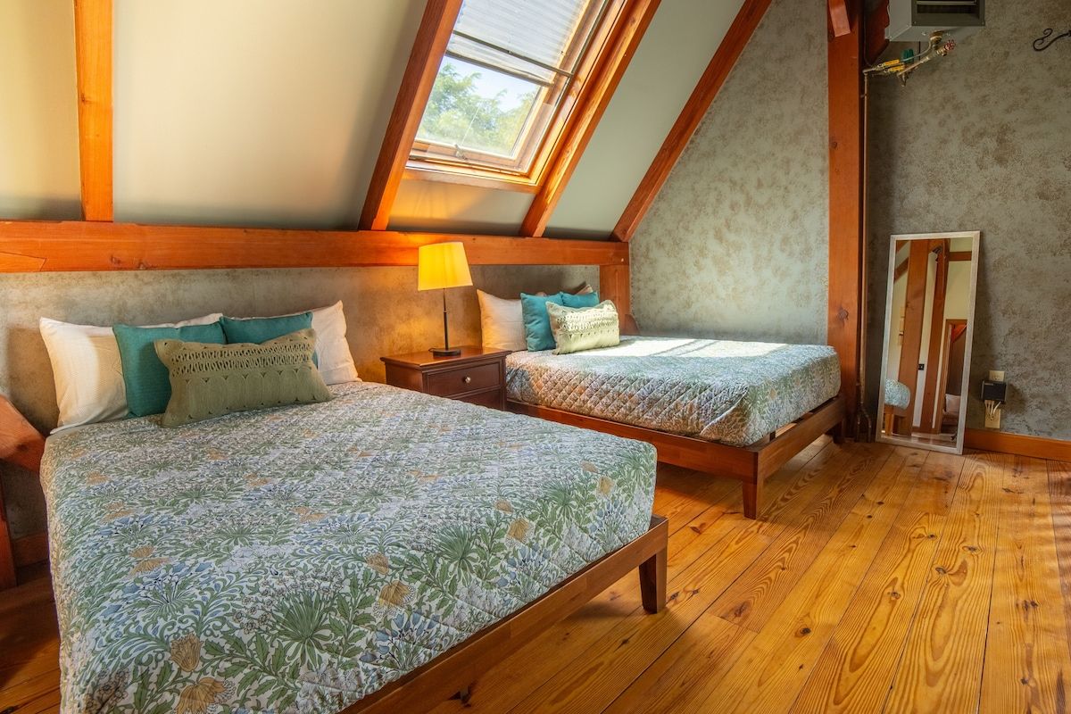 Cozy bedroom with two beds and a large window