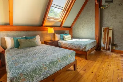 Cozy bedroom with two beds and a large window