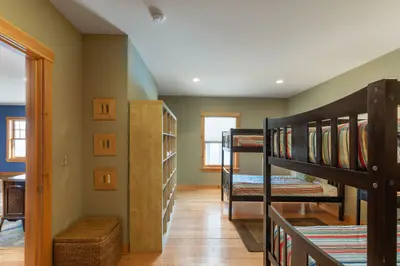 A cozy bedroom with bunk beds and a window, perfect for a family vacation