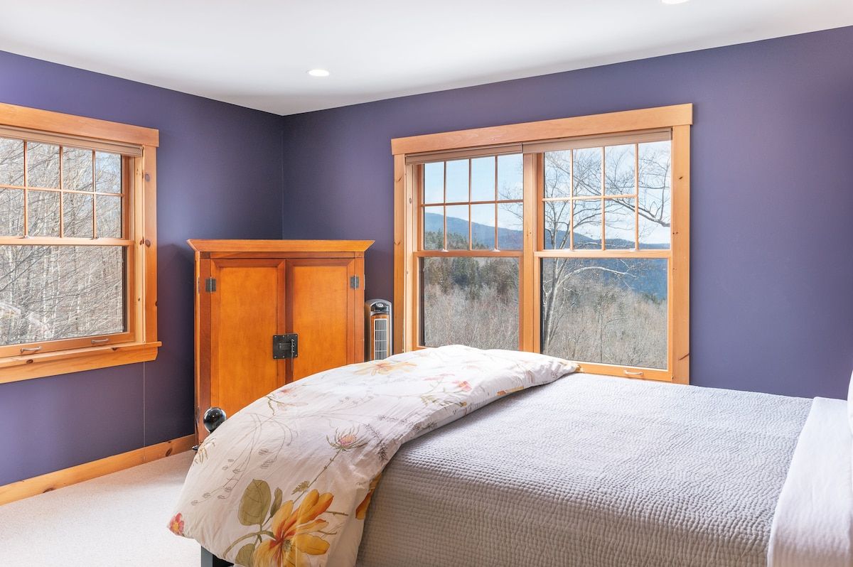 Spacious master bedroom with king bed and mountain views