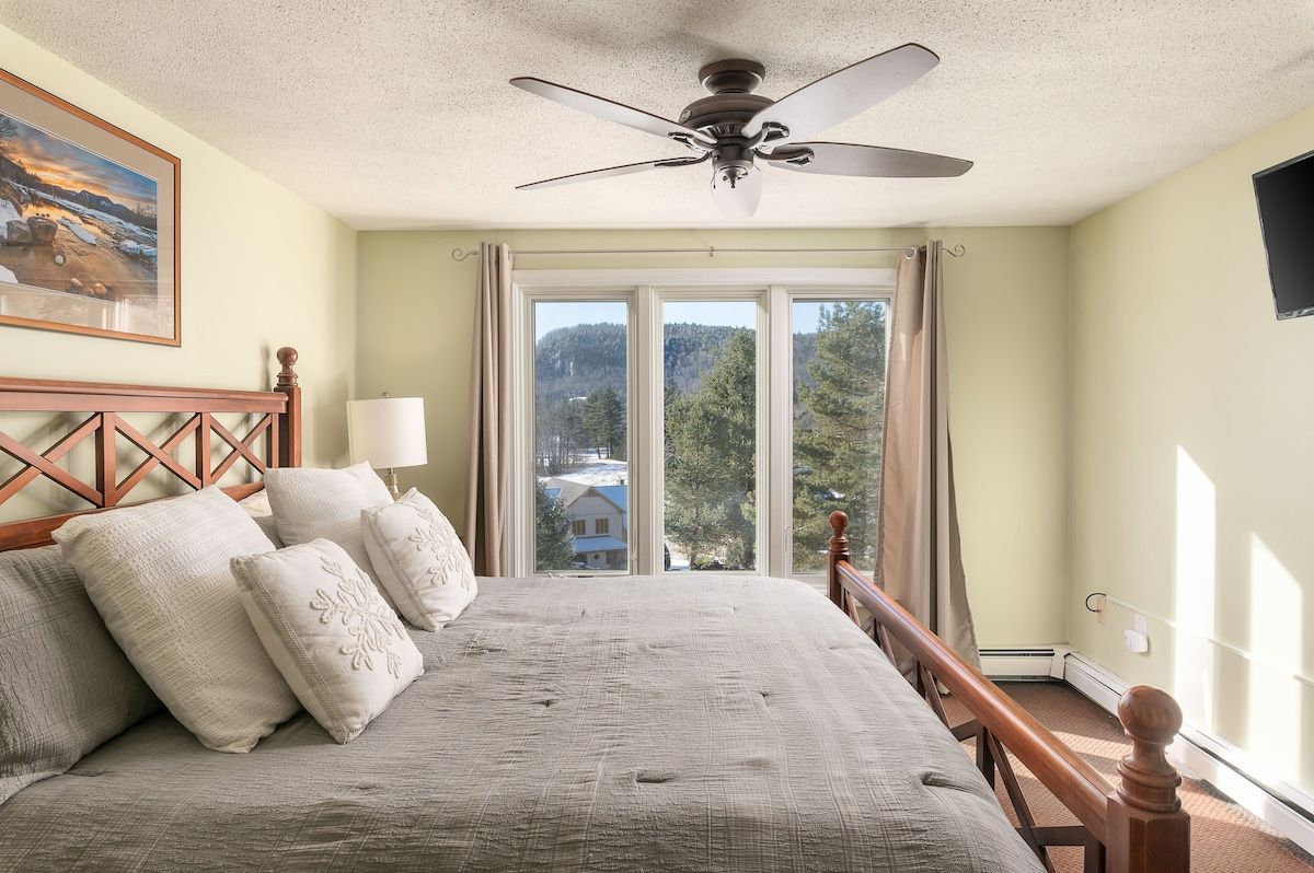 Spacious master bedroom with king bed and mountain views