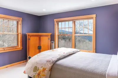 Spacious master bedroom with king bed and mountain views