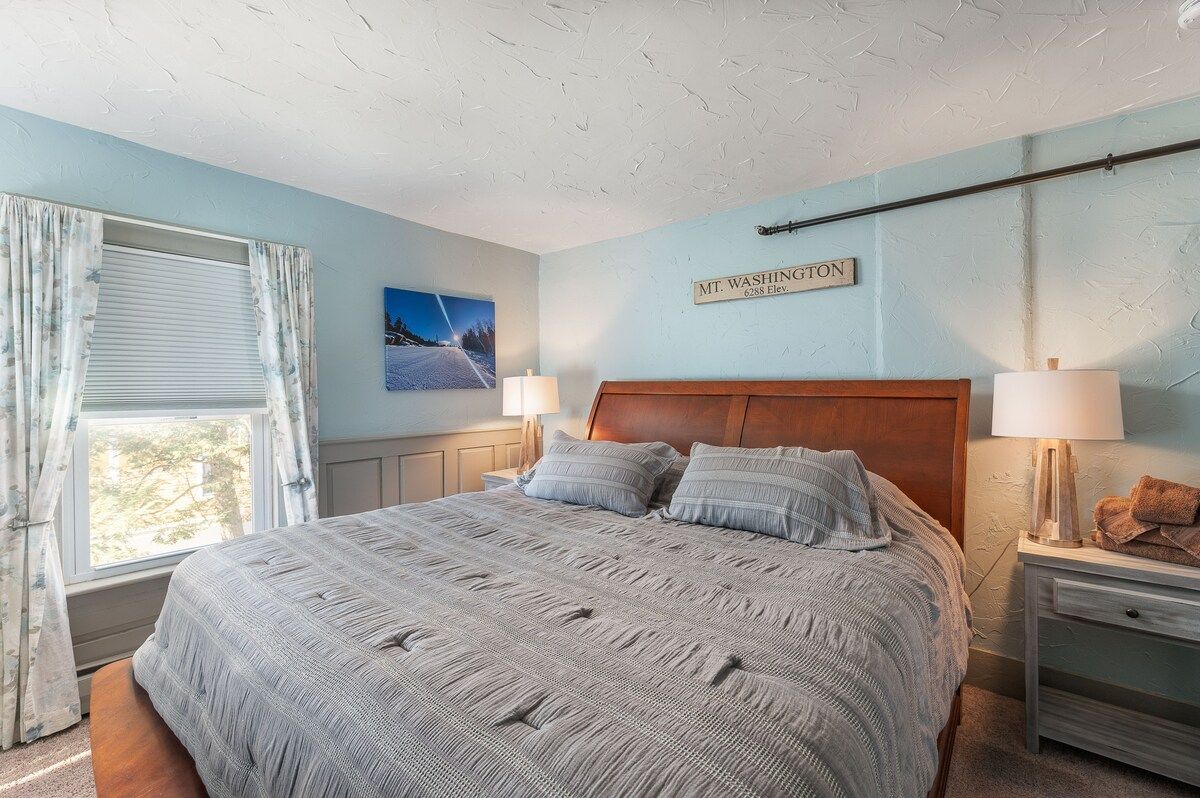 Spacious master bedroom with king bed and mountain views