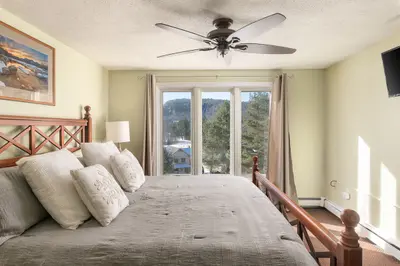 Spacious master bedroom with king bed and mountain views