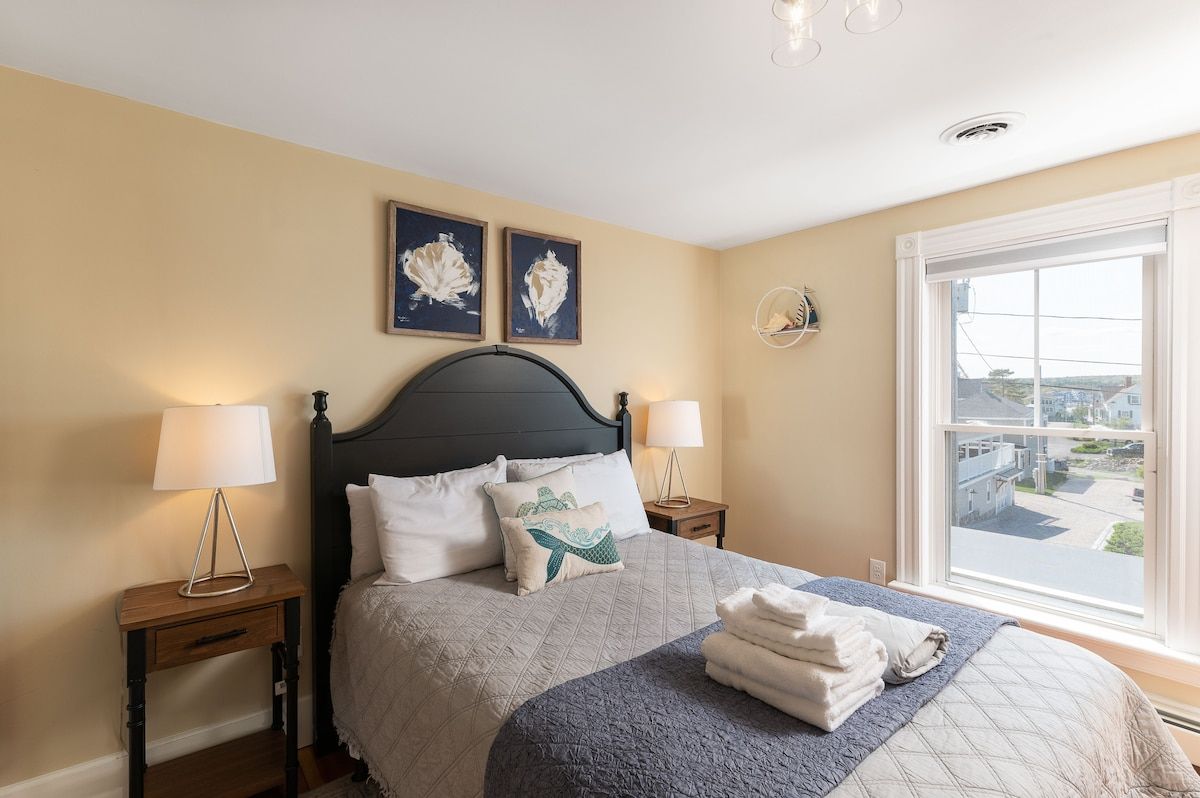 Spacious master bedroom with king bed and mountain views