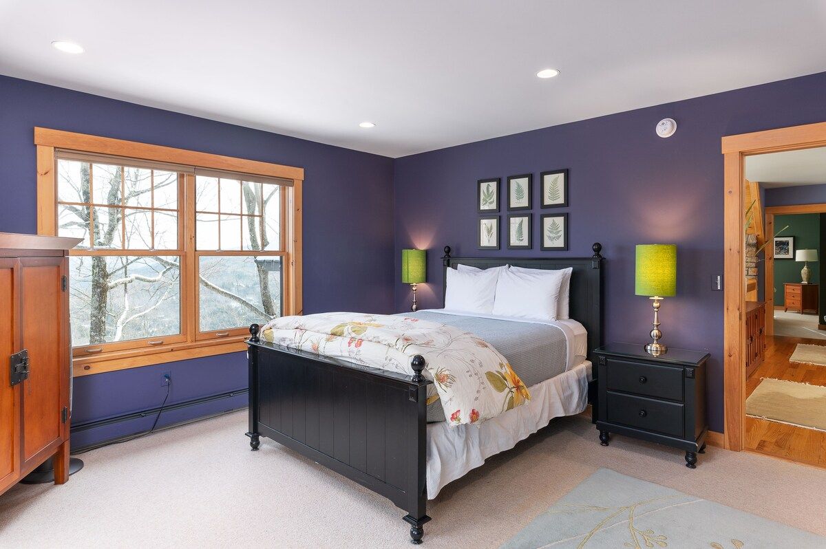 Spacious master bedroom with king bed and mountain views