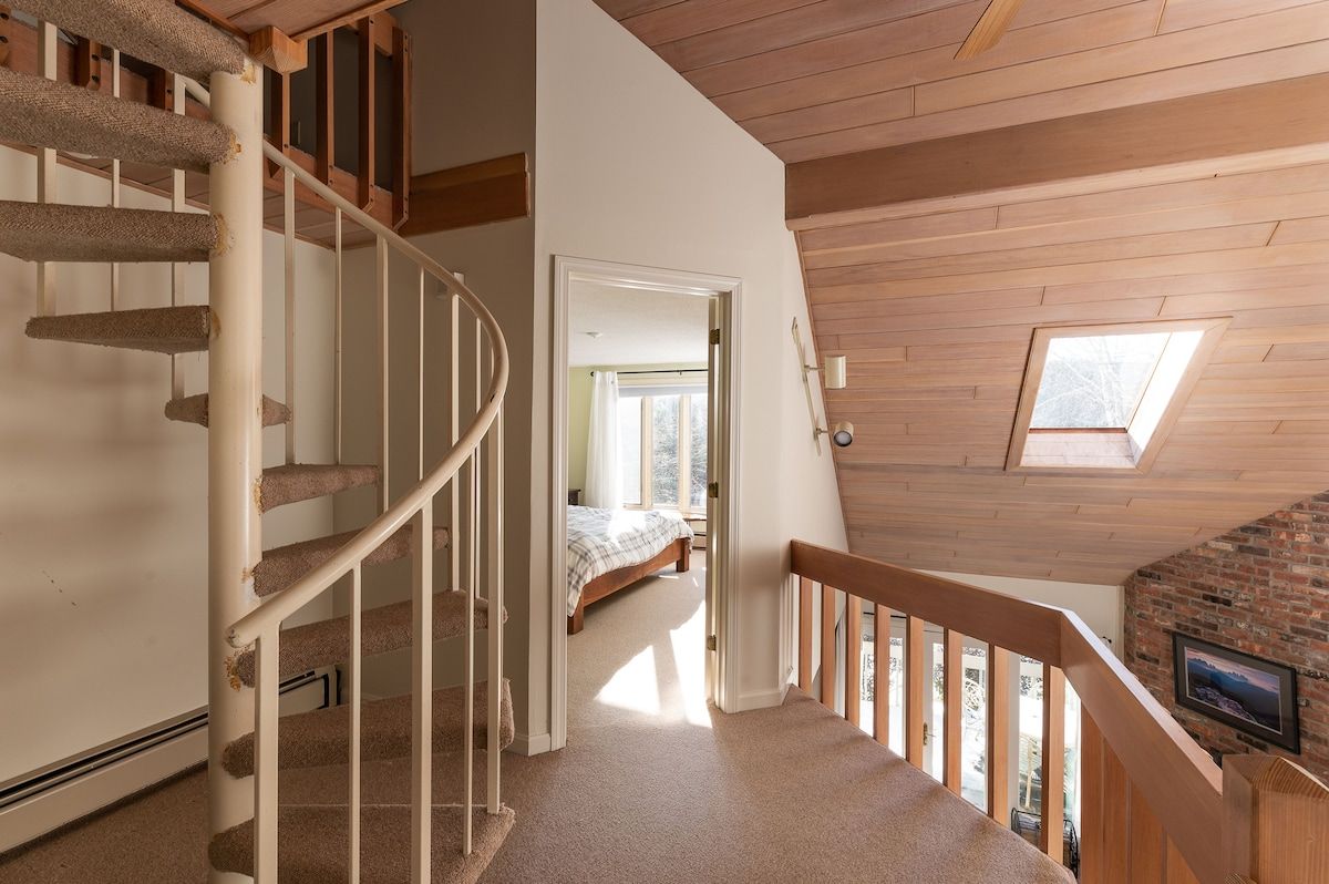 Spacious master bedroom with king bed and mountain views