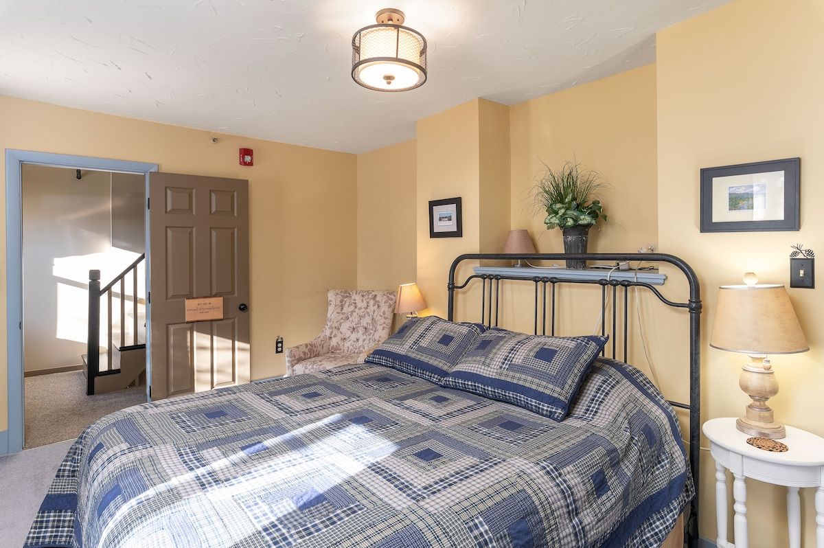 Spacious master bedroom with king bed and mountain views