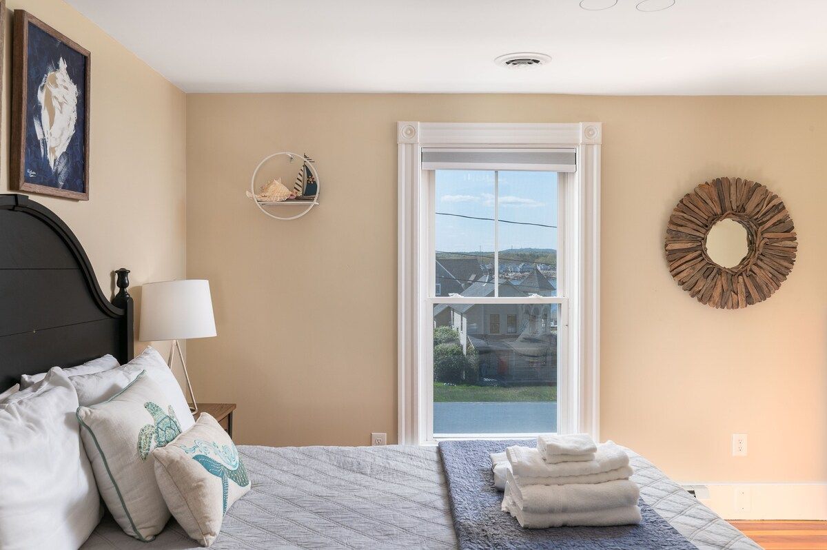 Spacious master bedroom with king bed and mountain views