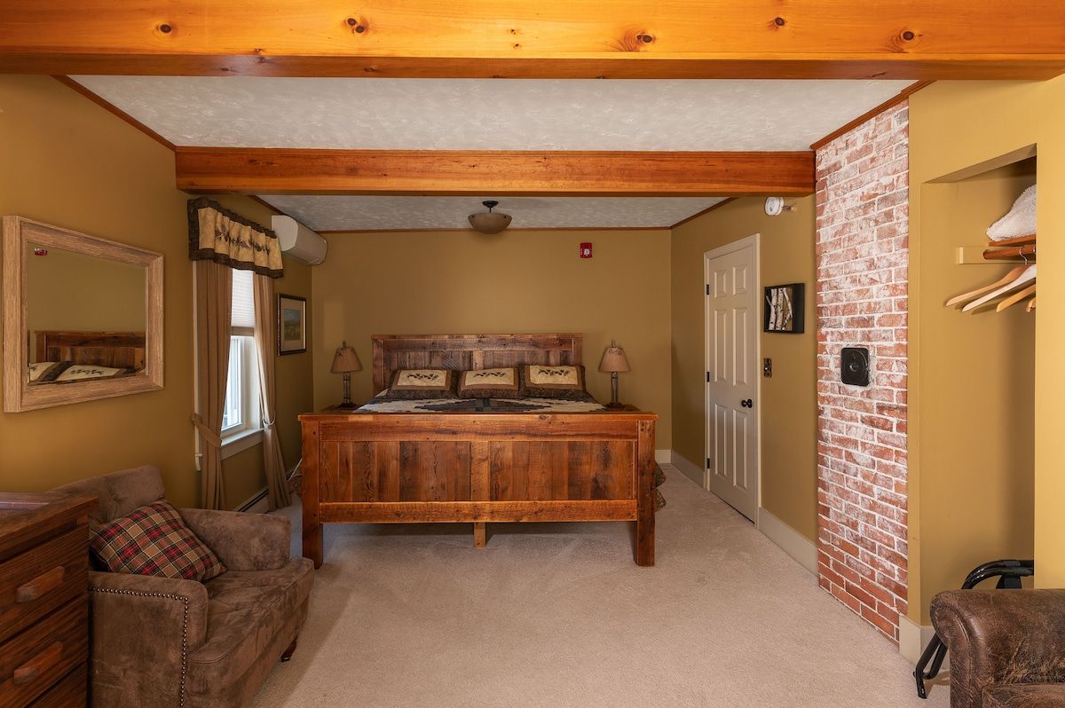 Spacious master bedroom with king bed and mountain views