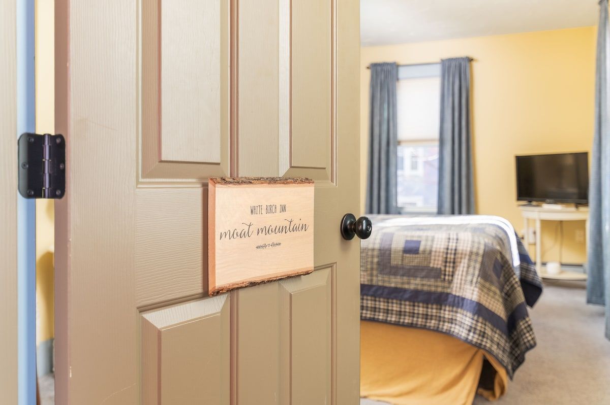 Spacious master bedroom with king bed and mountain views