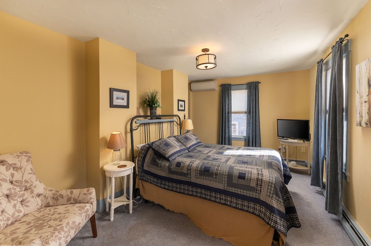 Spacious master bedroom with king bed and mountain views