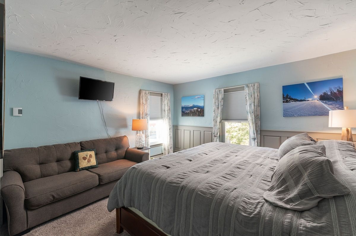 Spacious master bedroom with king bed and mountain views