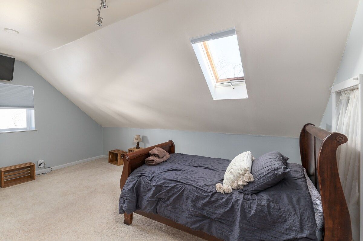 Spacious master bedroom with king bed and mountain views