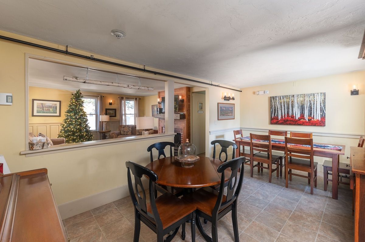 Cozy dining area with a large table and chairs, perfect for family meals or holiday gatherings.