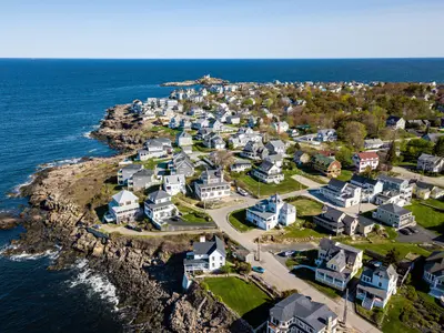 Aerial view of a coastal neighborhood with houses and ocean views