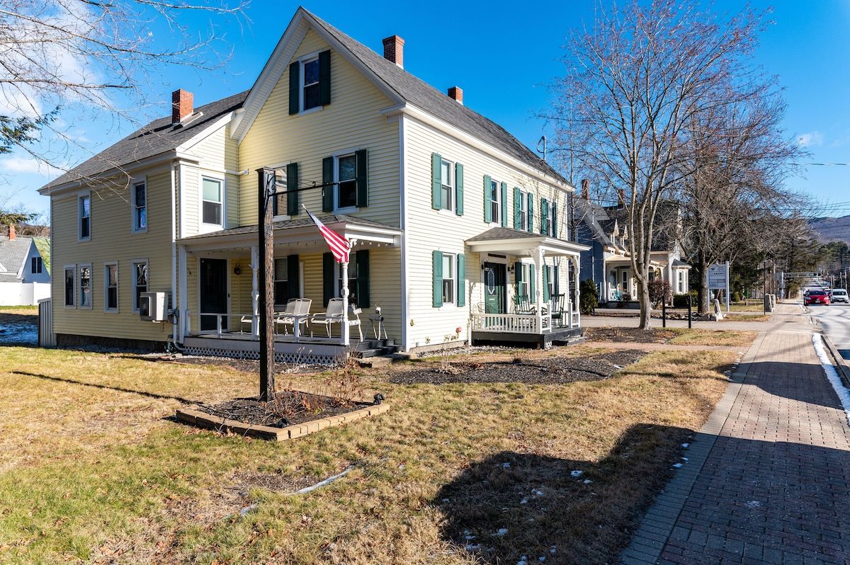 Two-story house with a porch and an American flag