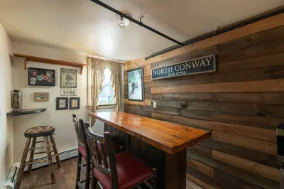 Cozy game room with a bar and two chairs, perfect for a relaxing evening