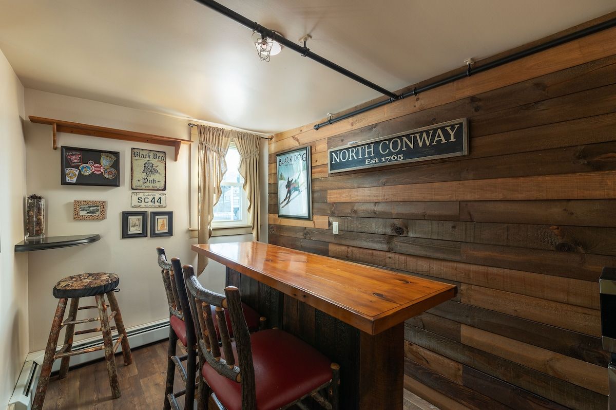 Cozy game room with a bar and two chairs, perfect for a relaxing evening