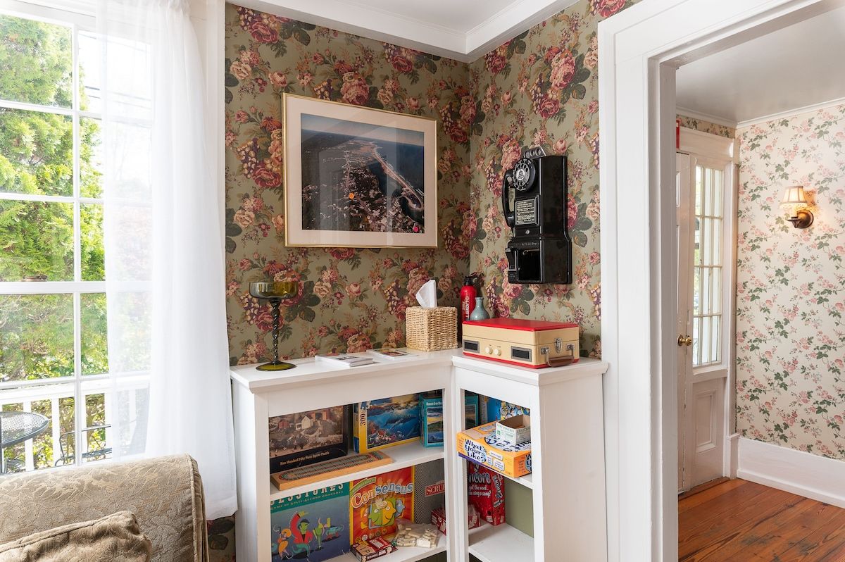 Cozy game room with a record player and board games on shelves