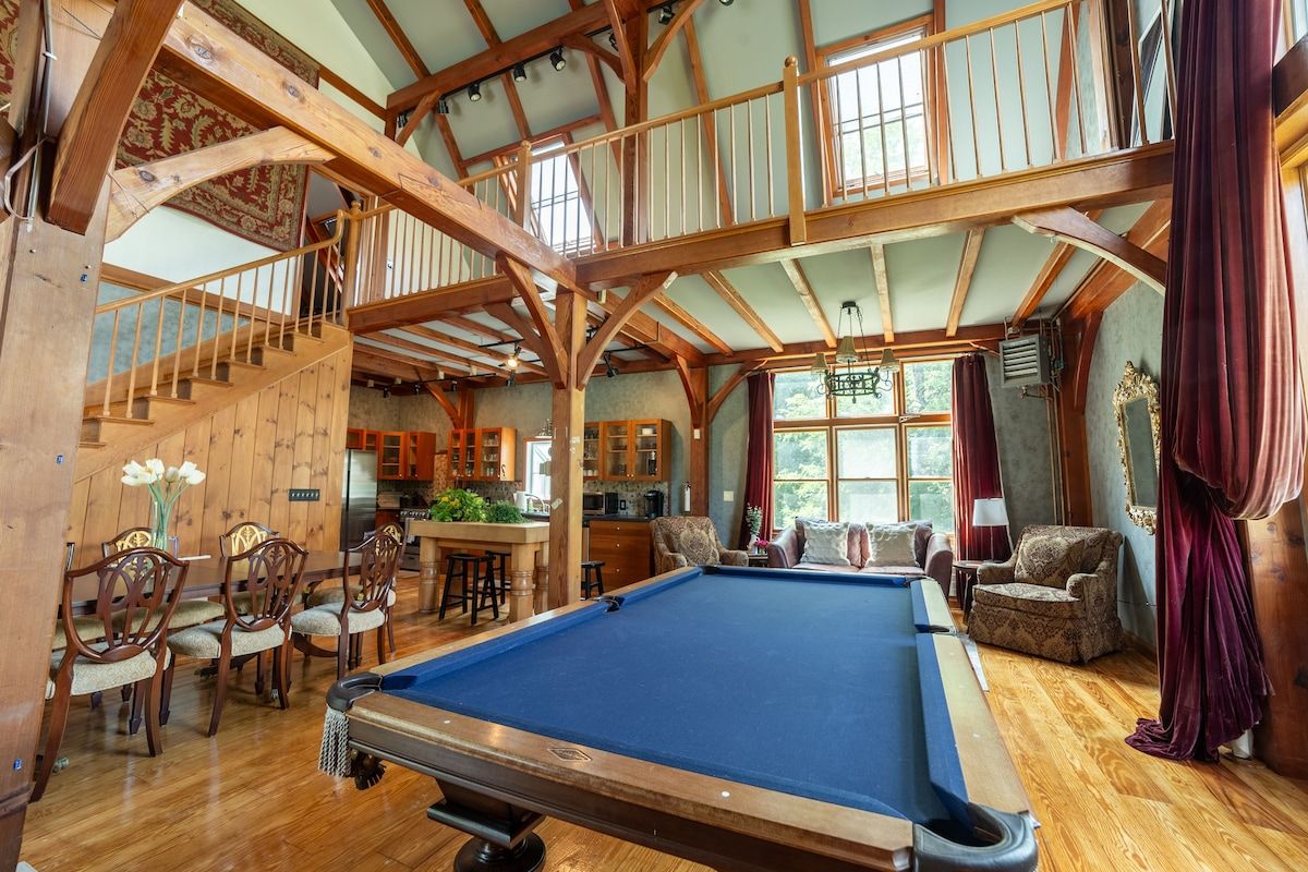 A spacious game room with a pool table and comfortable seating area.