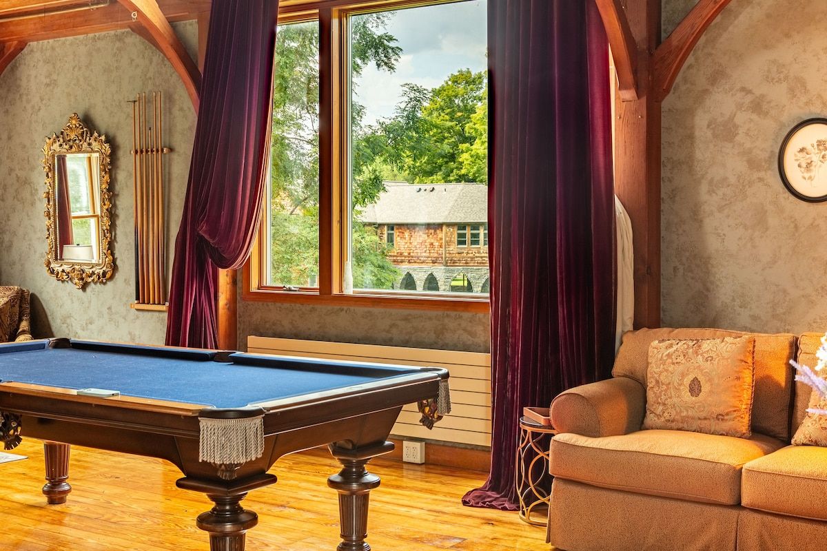 Cozy game room with a pool table and comfortable seating area