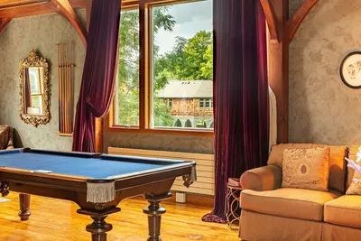 Cozy game room with a pool table and comfortable seating area