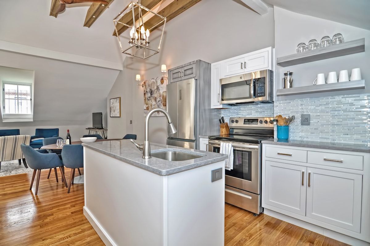 Modern kitchen with stainless steel appliances and a large island