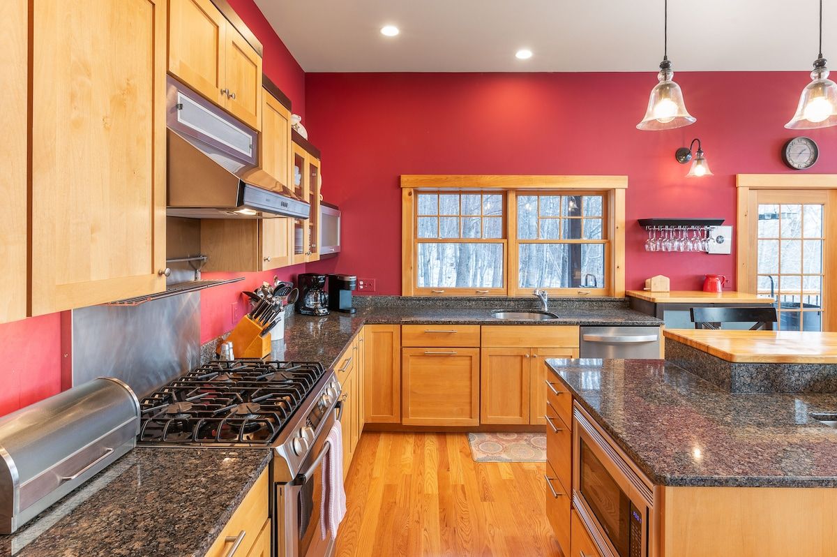 A well-equipped kitchen with granite countertops, stainless steel appliances, and a large island.
