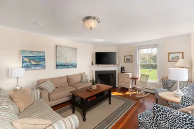 Cozy living room with a fireplace, TV, and comfortable seating area