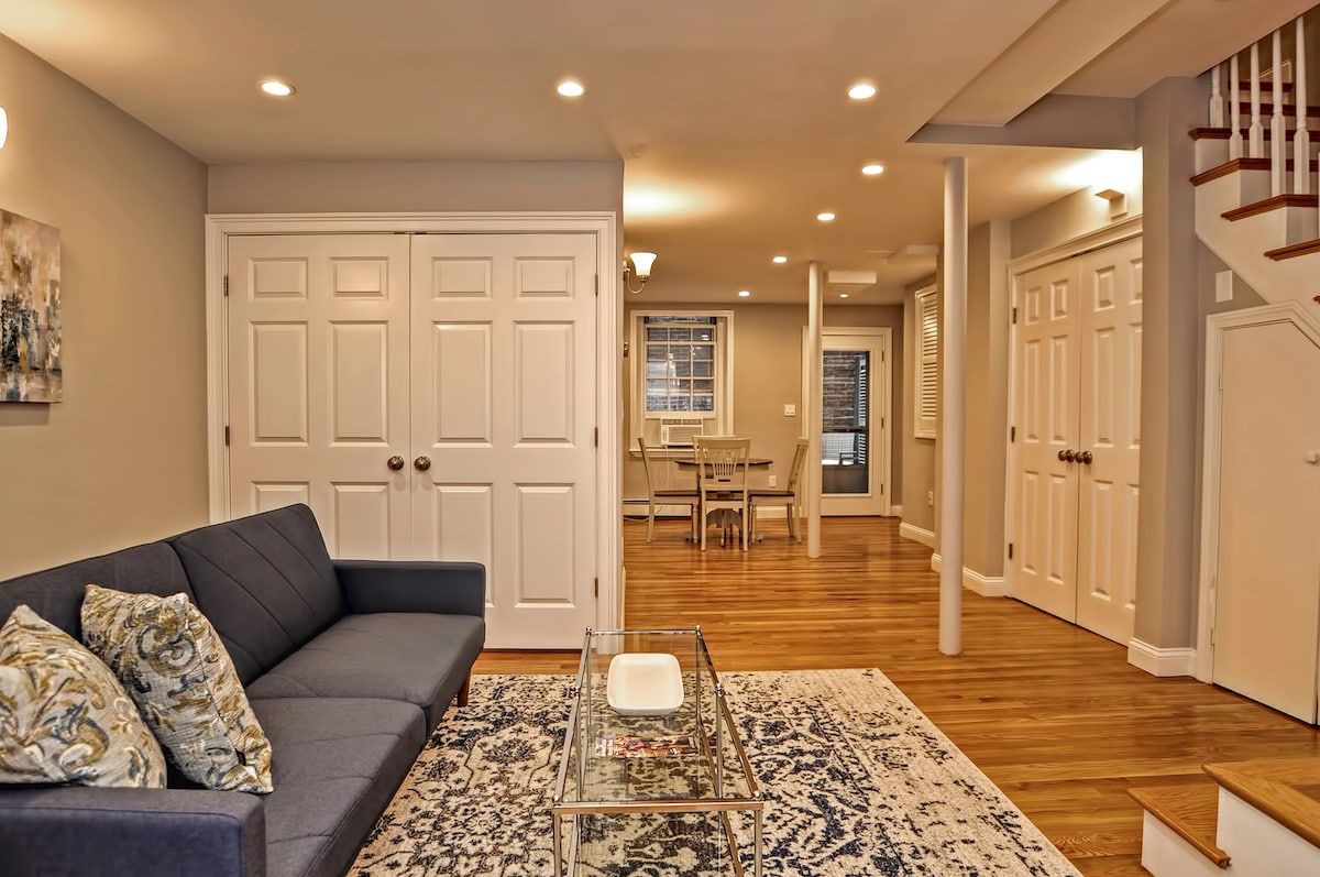 Cozy living room with gray sofa and patterned throw pillows on a rug