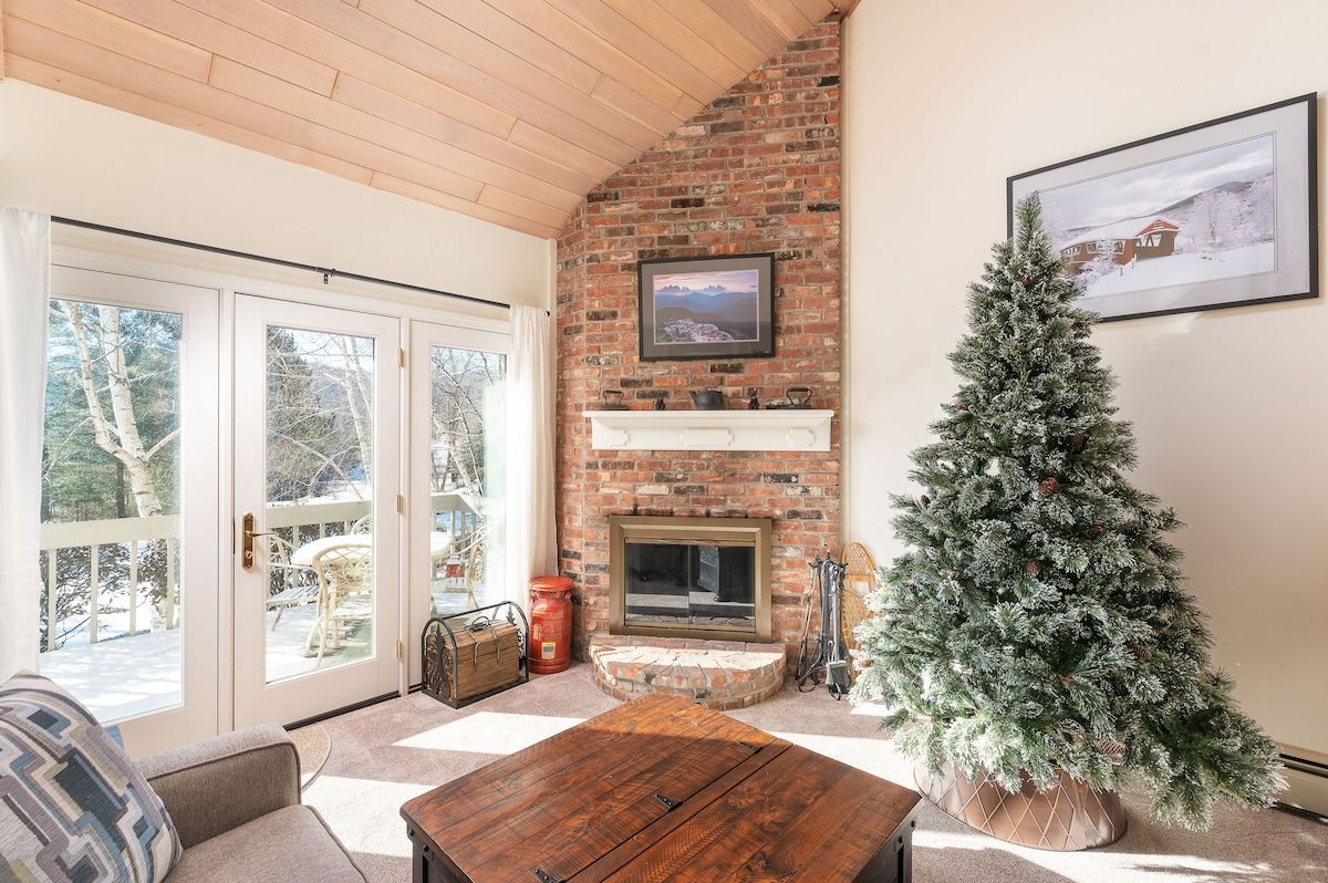 Cozy living room with a Christmas tree and a fireplace