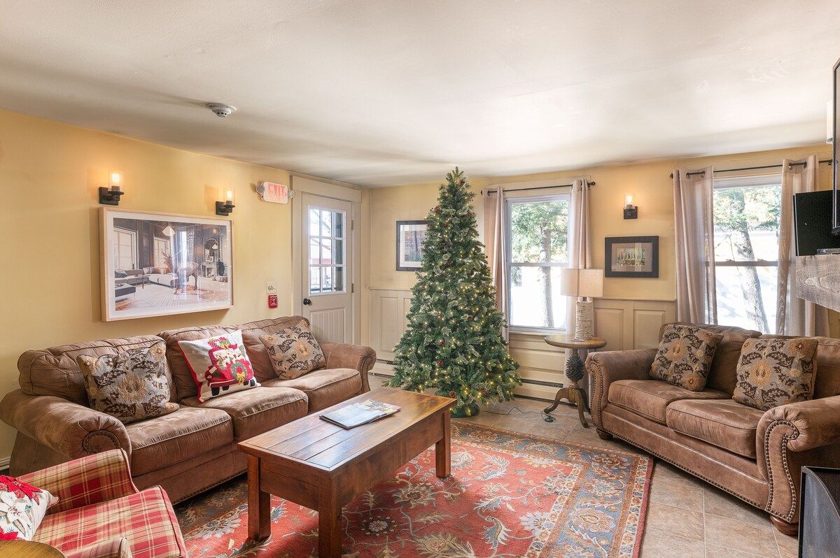 Cozy living room with Christmas tree and comfortable seating for a relaxing holiday stay