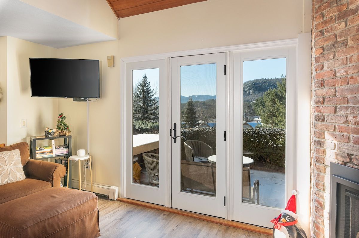 Cozy living room with a TV and comfortable seating area overlooking the mountains