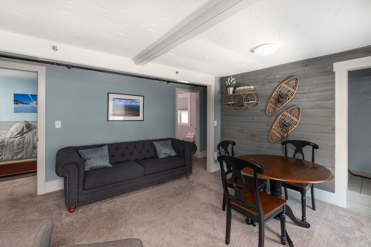 Cozy living room with a comfortable sofa and a dining table