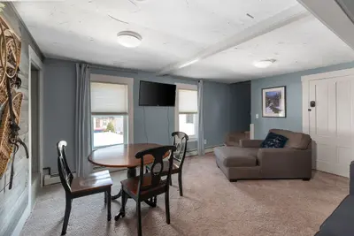 Cozy living room with comfortable couch and large TV on the wall.