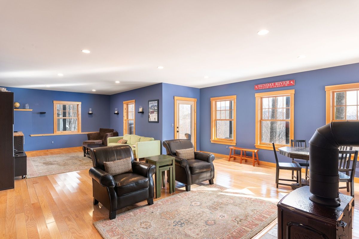 Cozy living room with comfortable seating and a warm wood-burning stove