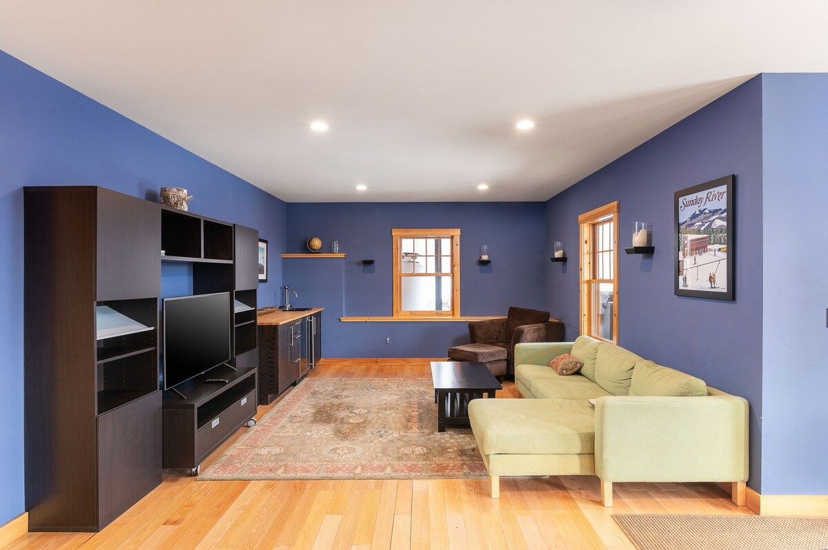 Cozy living room with a sectional sofa and large TV on the entertainment center